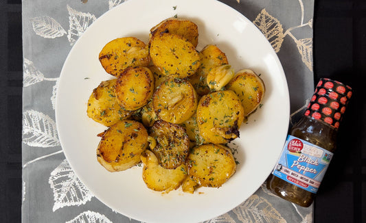 Puffed melting potatoes with a bottle of Elda's Kitchen Black Pepper sauce.